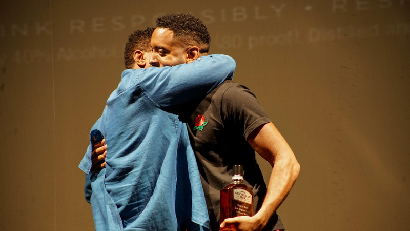 Robert Townsend hugging Anthony Rose at Gentleman Jack Real to Reel.